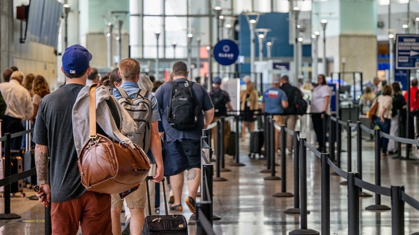 Passengers wait to pass through security at the Austin-Bergstrom International Airport