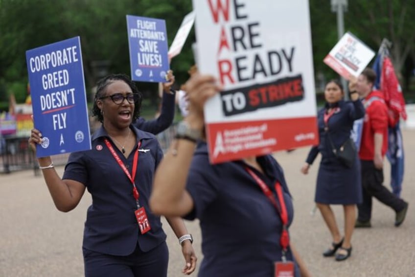 American Airlines flight attendants and their supporters form a picket line outside the Wh