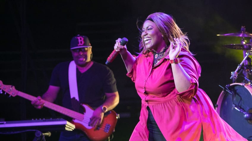 Mandisa smiling while performing