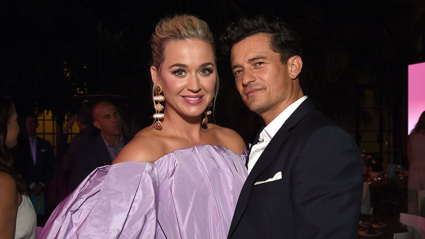 Katy Perry with blonde hair posing with Orlando Bloom