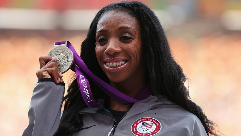 Lashina Demus holds the silver