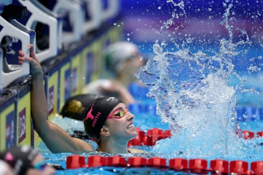 Regan Smith checks the scoreboard after setting a world record in the 100m backstroke fina