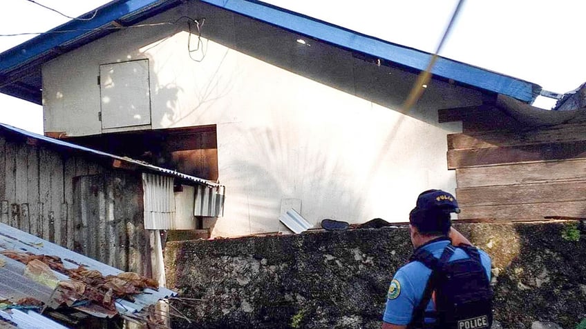 Philippine National Police officer checking area