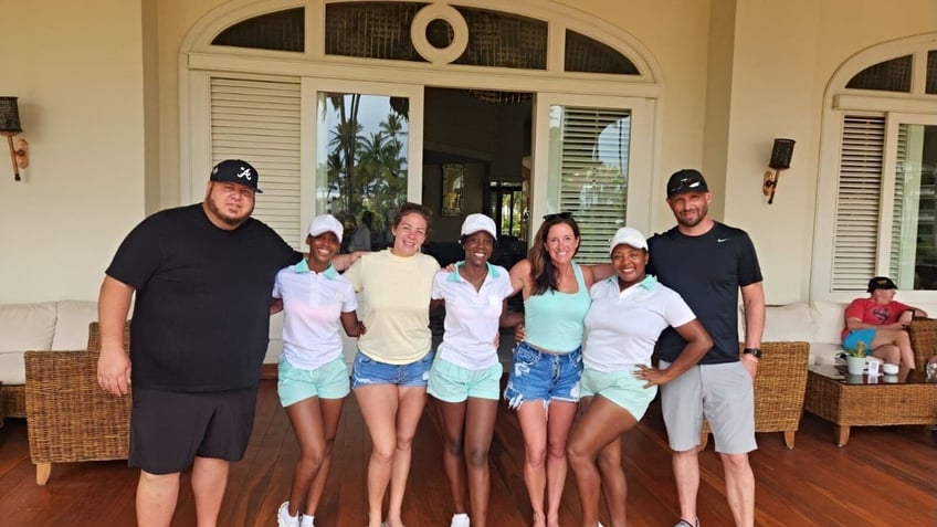 Maria Yannotti (third from left), Stephanie Smith (third from right), their significant others and hotel staff