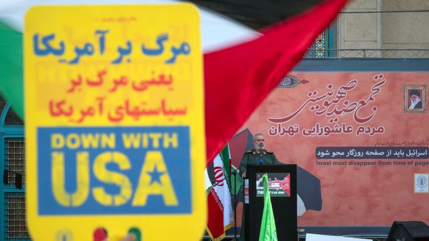 Iranian demonstrator holds anti-American sign.