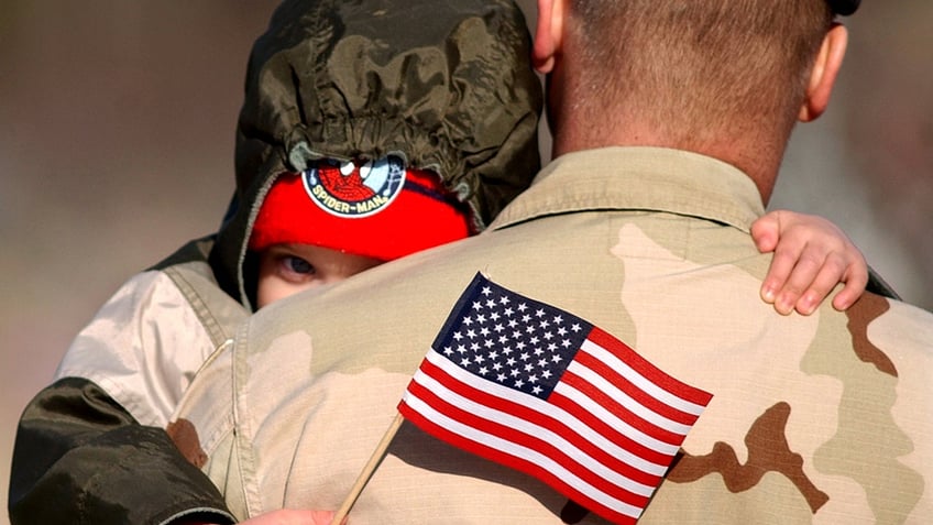 Soldier with child.