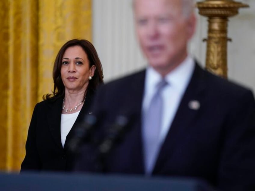 Vice President Kamala Harris listens as President Joe Biden speaks about distribution of C