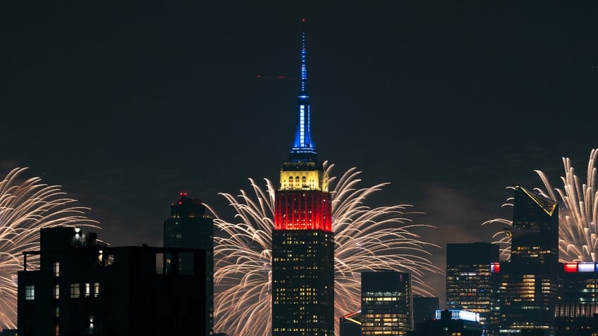 The Macy's 4th Of July fireworks show lights up the night sky as a backdrop to the Empire State Building on July 4, 2024 in New York City. The annual spectacle, lighting up the city since 1976, this time was launched from barges in the Hudson River, the first time in more than a decade not done from the East River. 