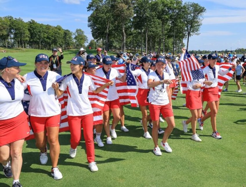 US captain Stacy Lewis, front center, leads the United States team in celebration after be