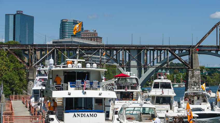 Boats in the Vol Navy on the Tennessee River outside Neyland Stadium with the Knoxville skyline in the background prior to a game between the Indiana State Sycamores and Tennessee Volunteers on September 9, 2017, at Neyland Stadium in Knoxville, TN.