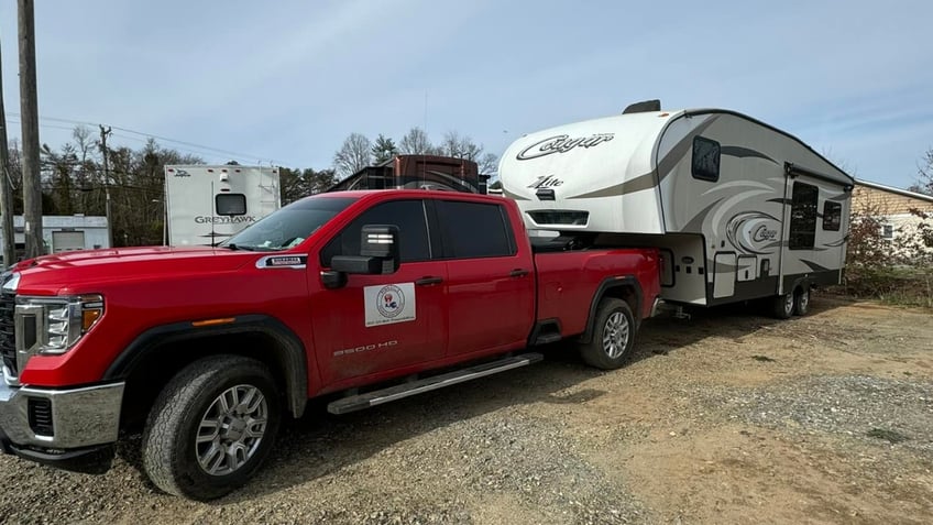 A Cajun Navy truck towing a camper