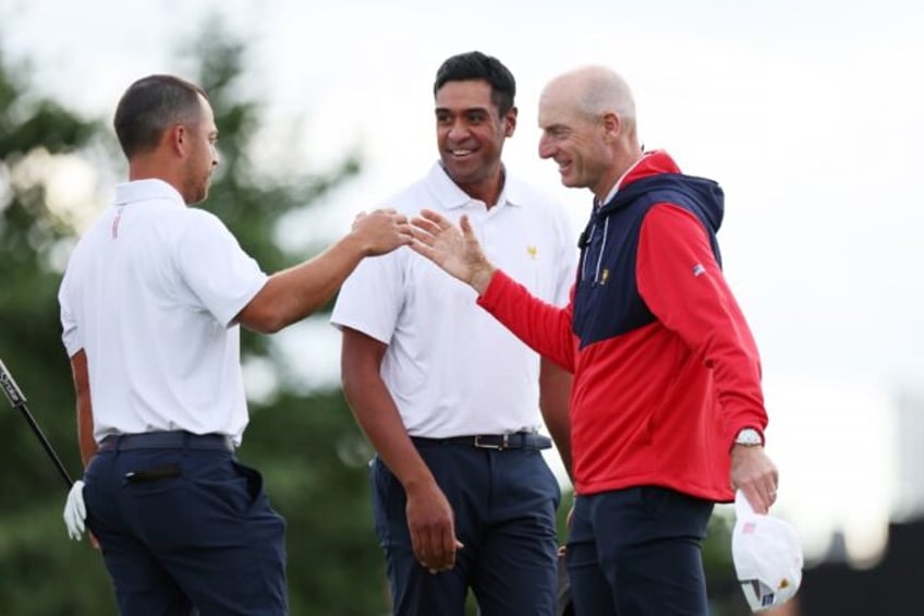 Second-ranked Xander Schauffele, left, and partner Tony Finau, center, celebrate with US c