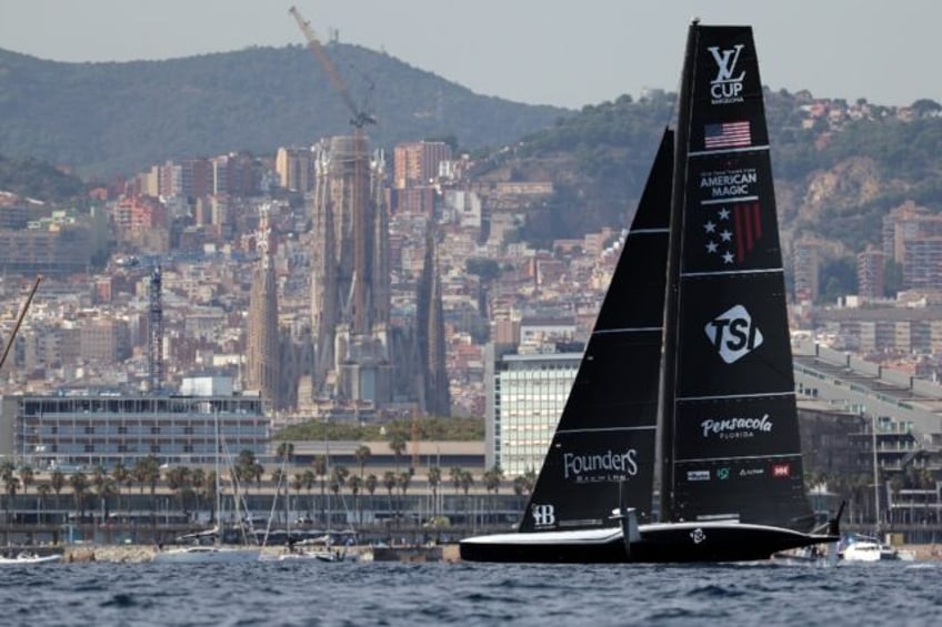 American Magic sails in front of the Sagrada Familia basilica during the Luis Vuitton Cup