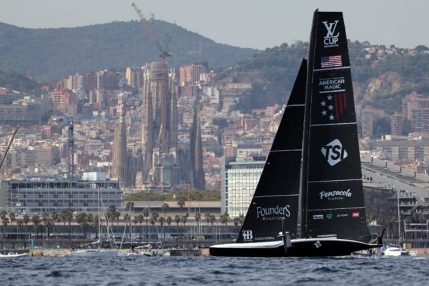 American Magic sails in front of the Sagrada Familia basilica during the Luis Vuitton Cup