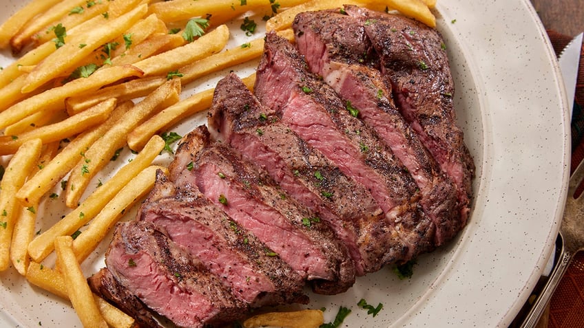 Steak Frites - Medium Rare Strip Loin Steak with Shoe String French Fries and Mayo.