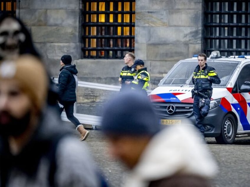 Netherlands' Police officers patrol on Dam Square in Amsterdam, on November 9, 2024. Extra