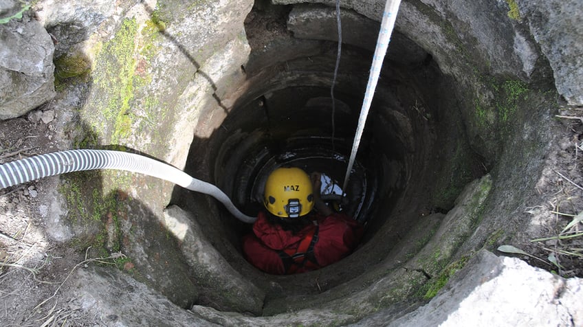 Man going down into the well