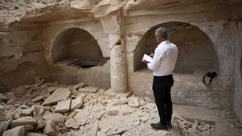 Man observing rubble in Syria