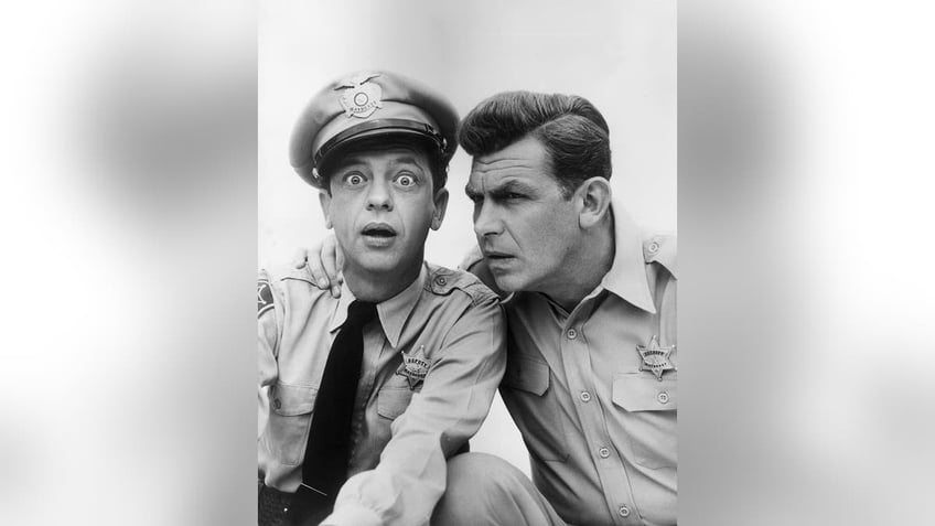 Andy Griffith leaning against a surprise Don Knotts in costume.