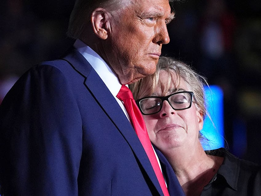 Republican presidential nominee former President Donald Trump embraces Patty Morin, mother