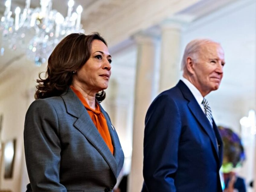 President Joe Biden and Vice President Kamala Harris walk through the Cross Hall as they a