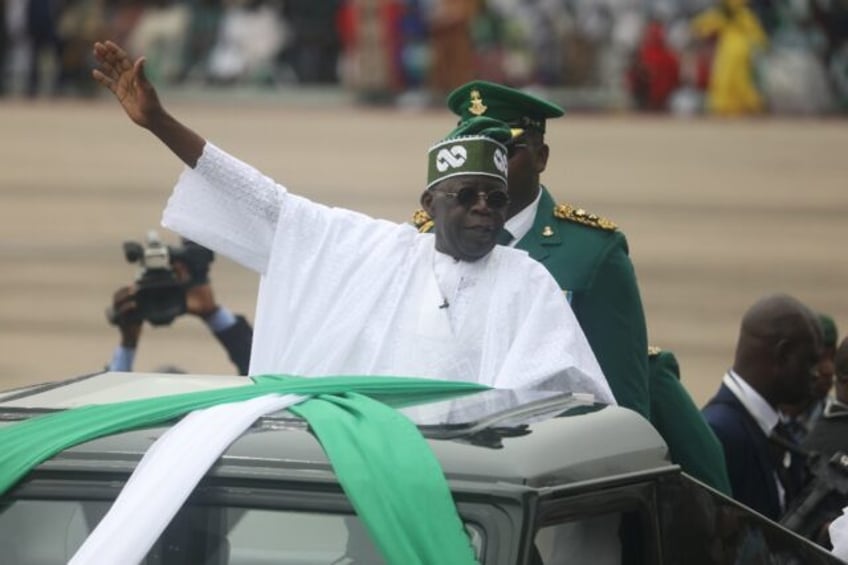 Nigeria's President Bola Tinubu (C) was sworn in on May 29 and has already begun major eco