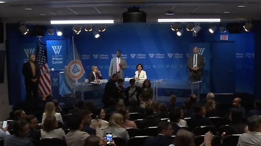 angry climate change protestors force commerce secretary gina raimondo to flee talk at the wilson center