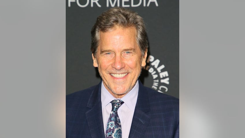 A close-up of Tim Matheson smiling in a suit.