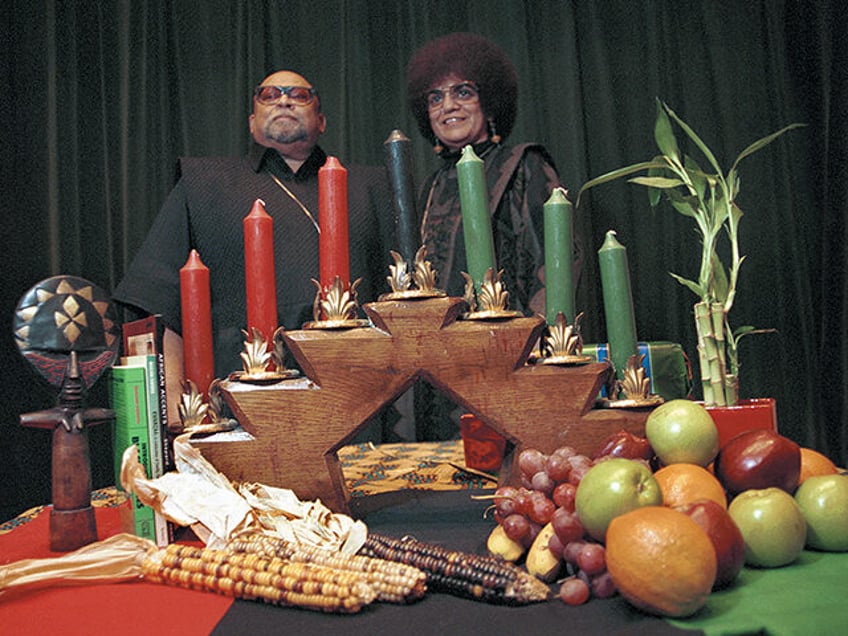 Portrait of African American author, activist, and professor Maulana Karenga with his wife Tiamoya celebrating Kwanzaa in 2000. (Robert Abbott Sengstacke/Getty Images)