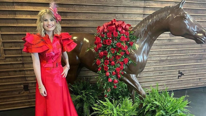 anna nicole smiths dannielynn birkhead posing in a red gown