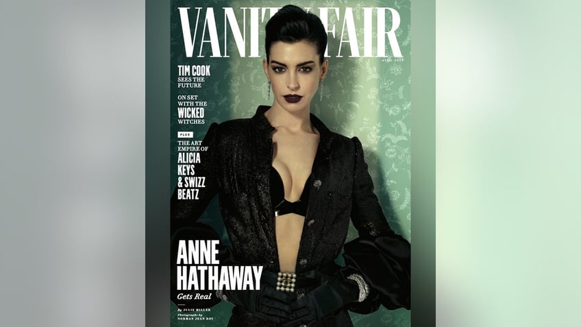 Anne Hathaway in a black bra and jacket with black lipstick on the cover of Vanity Fair