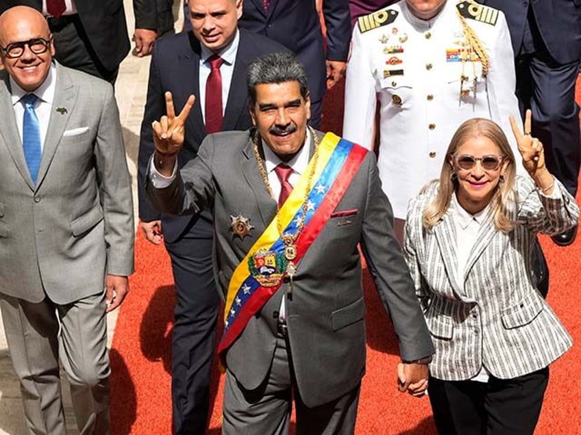 Venezuelan President Nicolas Maduro, center, and first lady Cilia Flores arrive to the National Assembly for the annual presidential address in Caracas, Venezuela, Monday, Jan. 15, 2024. (AP Photo/Ariana Cubillos)