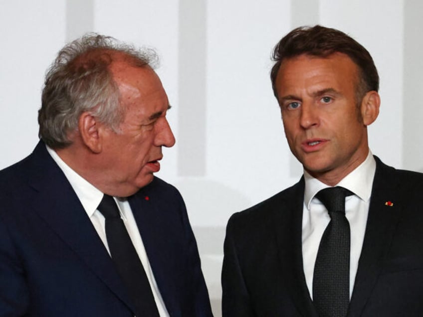 France's President Emmanuel Macron (R) speaks with France's Prime Minister Francois Bayrou