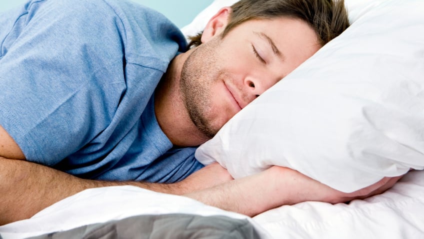 Man comfortably sleeping in his bed