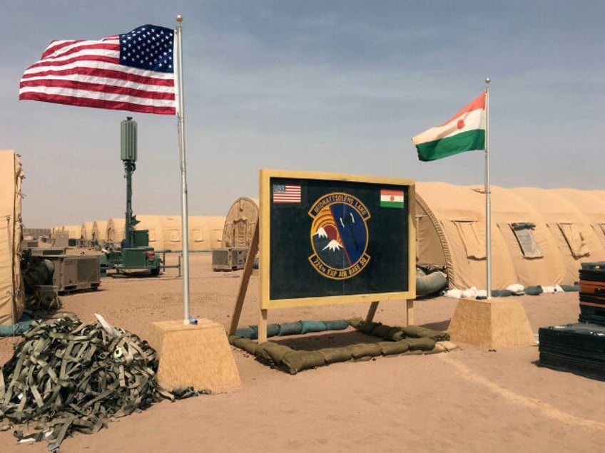 FILE - A U.S. and Niger flag are raised side …