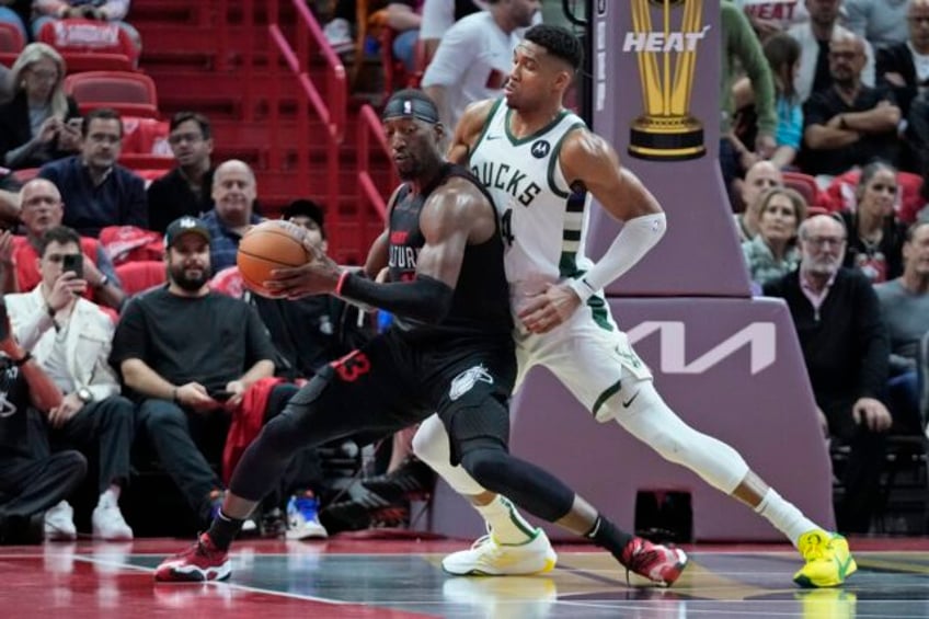 antetokounmpo lillard combine for 65 and bucks earn quarterfinal berth by topping heat 131 124