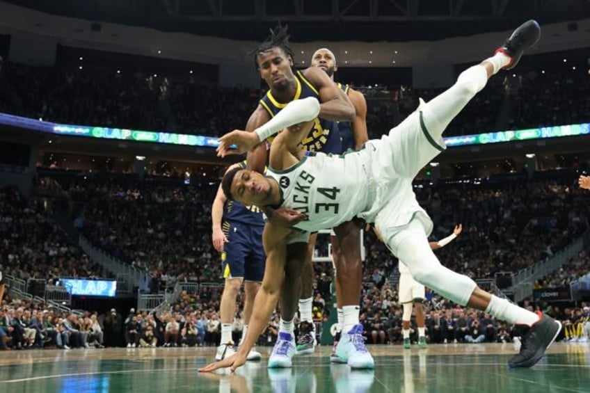 Milwaukee's Giannis Antetokounmpo is fouled by Indiana's Aaron Nesmith during a stormy clash between the two teams