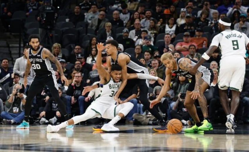 Milwaukee's Giannis Antetokounmpo loses control of the ball as he drives on Victor Wembanyama of the San Antonio Spurs in the Bucks' 125-121 NBA victory