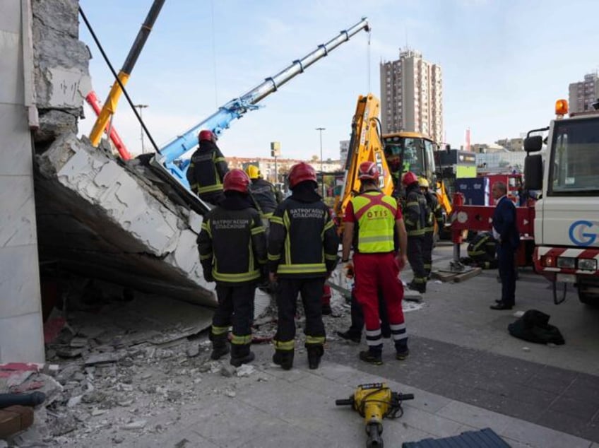 Rescue service workers inspect a scene as a roof collapsed at a railway station, Friday No