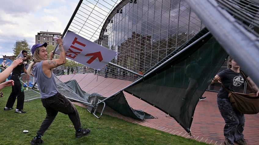 Protester pulling on a barricade