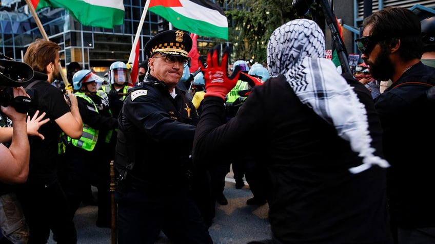 Protesters clash with the police during a protest in support of Palestinians near the Israeli consulate, as the Democratic National Convention