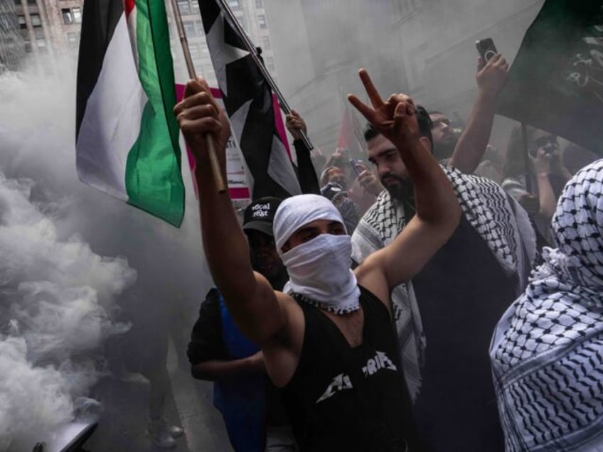 NEW YORK, NEW YORK - SEPTEMBER 2: People walk through smoke as they attend a protest in su