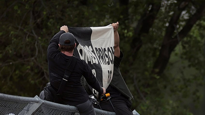 Pro-Palestine protesters on NASCAR fence