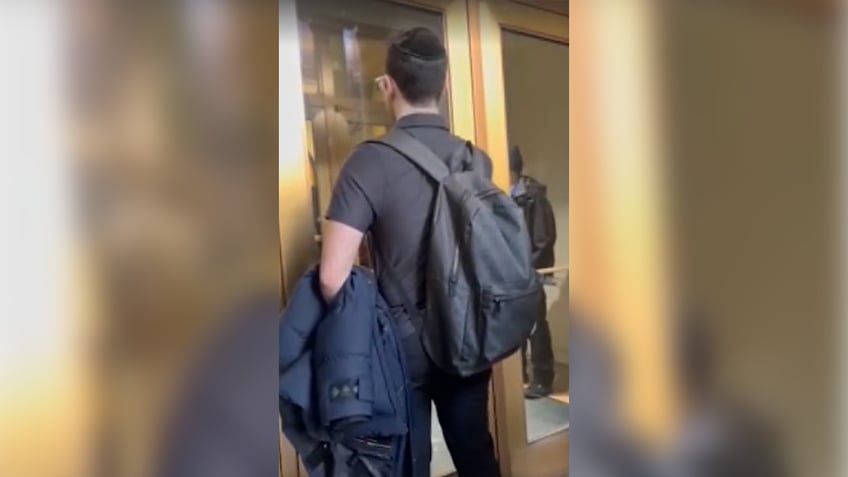 Students try to enter the door of a building at Barnard College in New York City