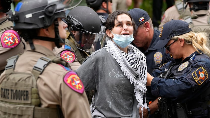 A woman is arrested at a pro-Palestinan protest