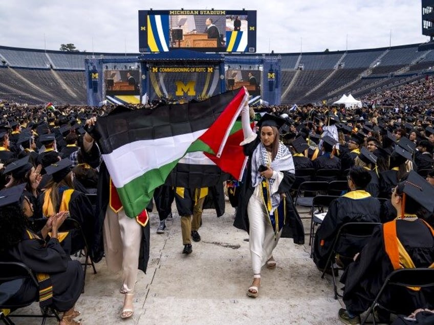 Salma Hamamy carries a Flag of Palestine during a Pro-Palestinian protest during the Unive