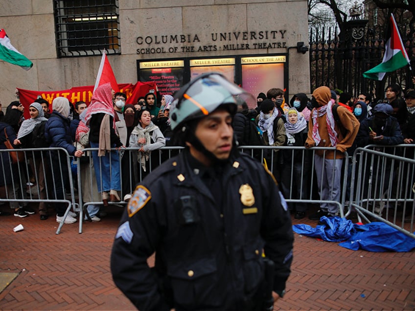 An NYPD officer stand guard as pro-Palestinian protesters gather outside of Columbia University in New York City on April 18, 2024. Officers cleared out a pro-Palestinian campus demonstration on April 18, a day after university officials testified about anti-Semitism before Congress. Leaders of Columbia University defended the prestigious New York school's efforts to combat anti-Semitism on campus at a fiery congressional hearing on April 17. (Photo by Kena Betancur / AFP) (Photo by KENA BETANCUR/AFP via Getty Images)
