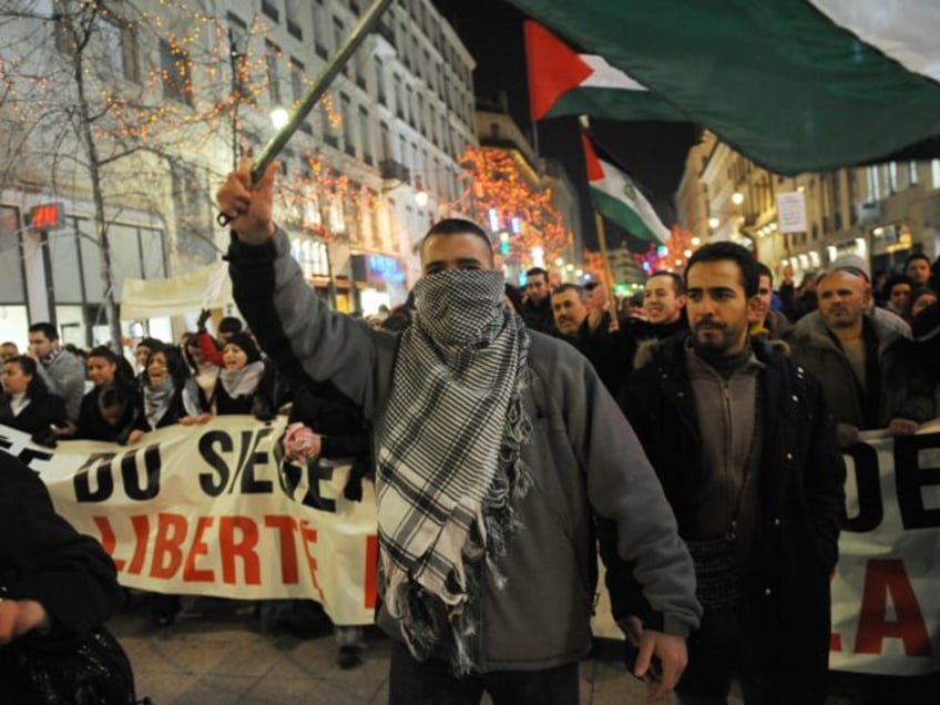 People demonstrate against the Israeli over air attacks on the Gaza Strip which have kille