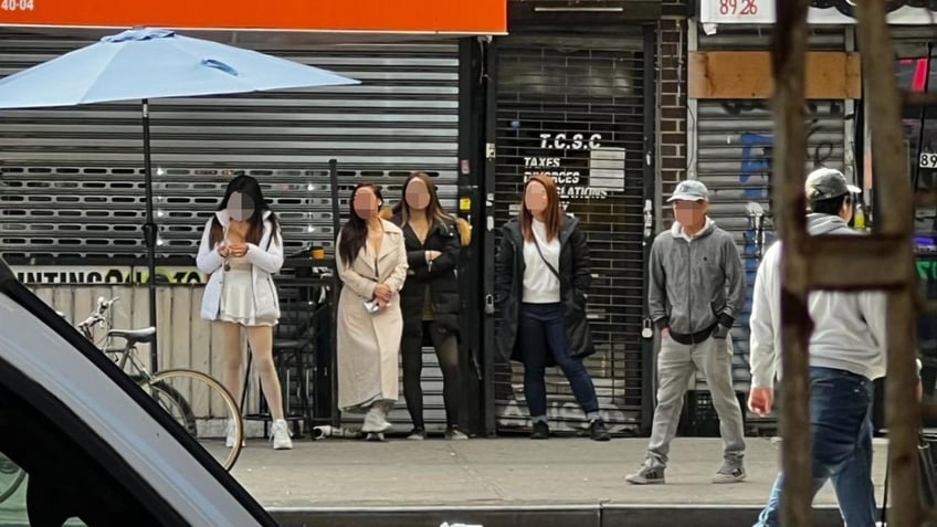 Sex workers lined up on a street in Queens