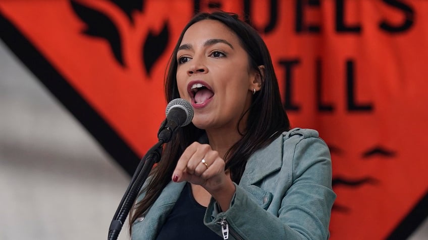 aoc joins thousands in new york climate change march with furious message for biden